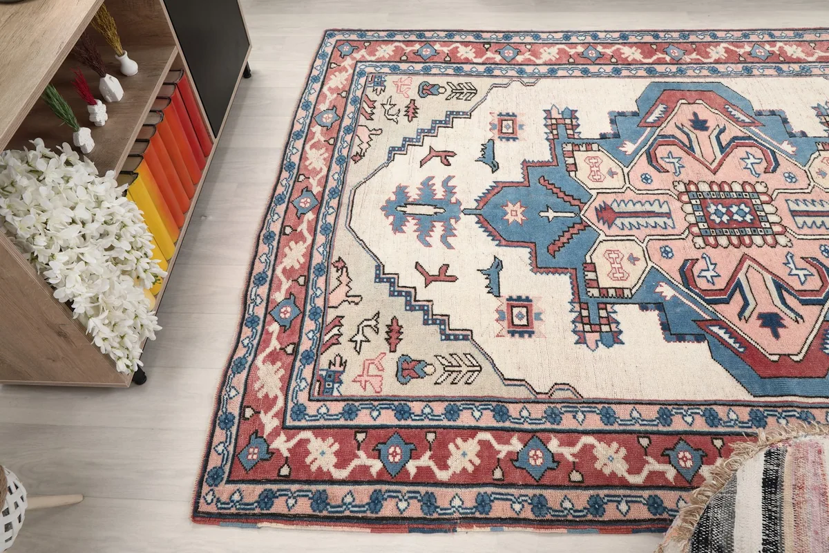 Angled view of the rug on a light floor, capturing the full pattern and its presence in a room.