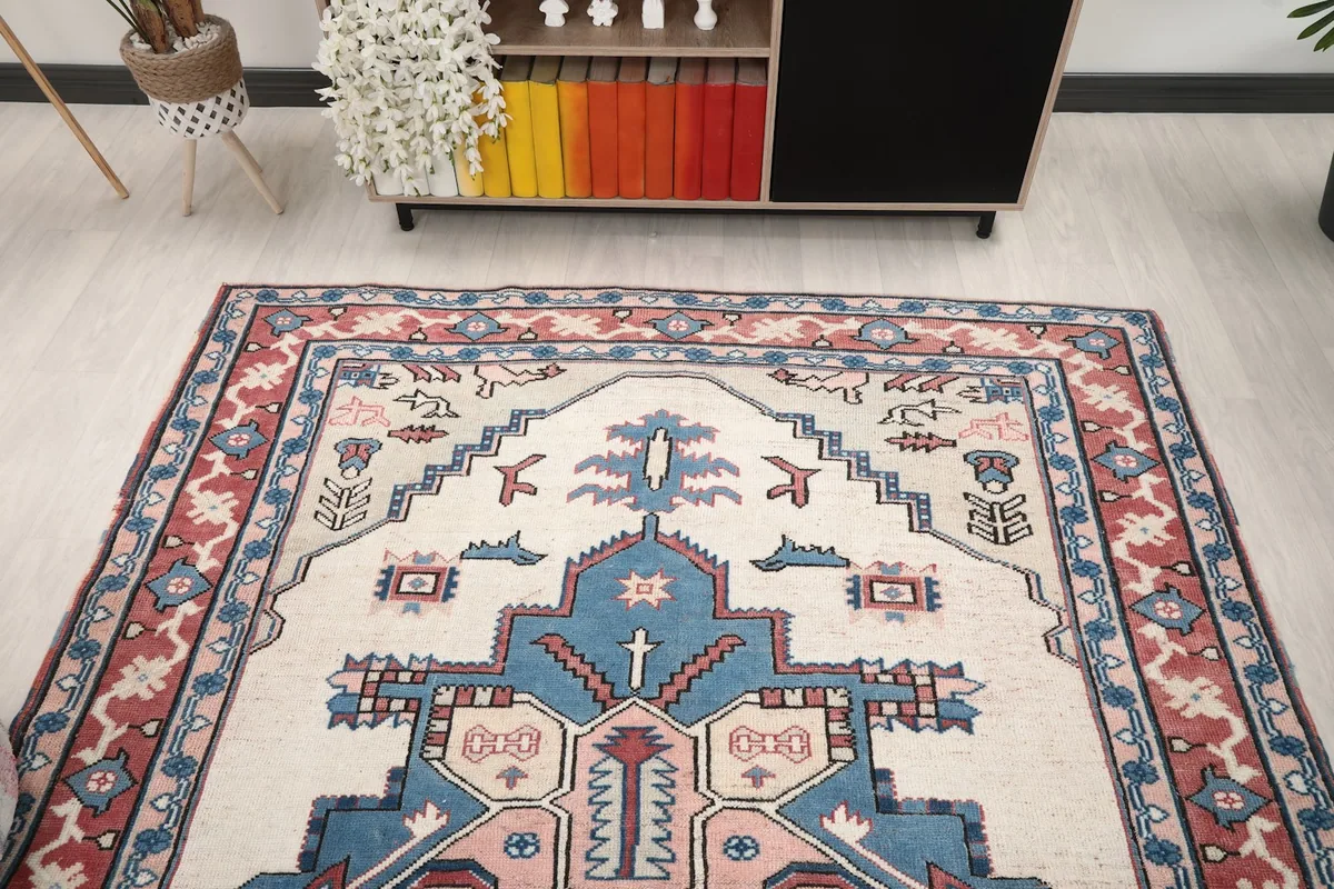 View of the rug from one end in a room, emphasizing the geometric patterns and overall color scheme.