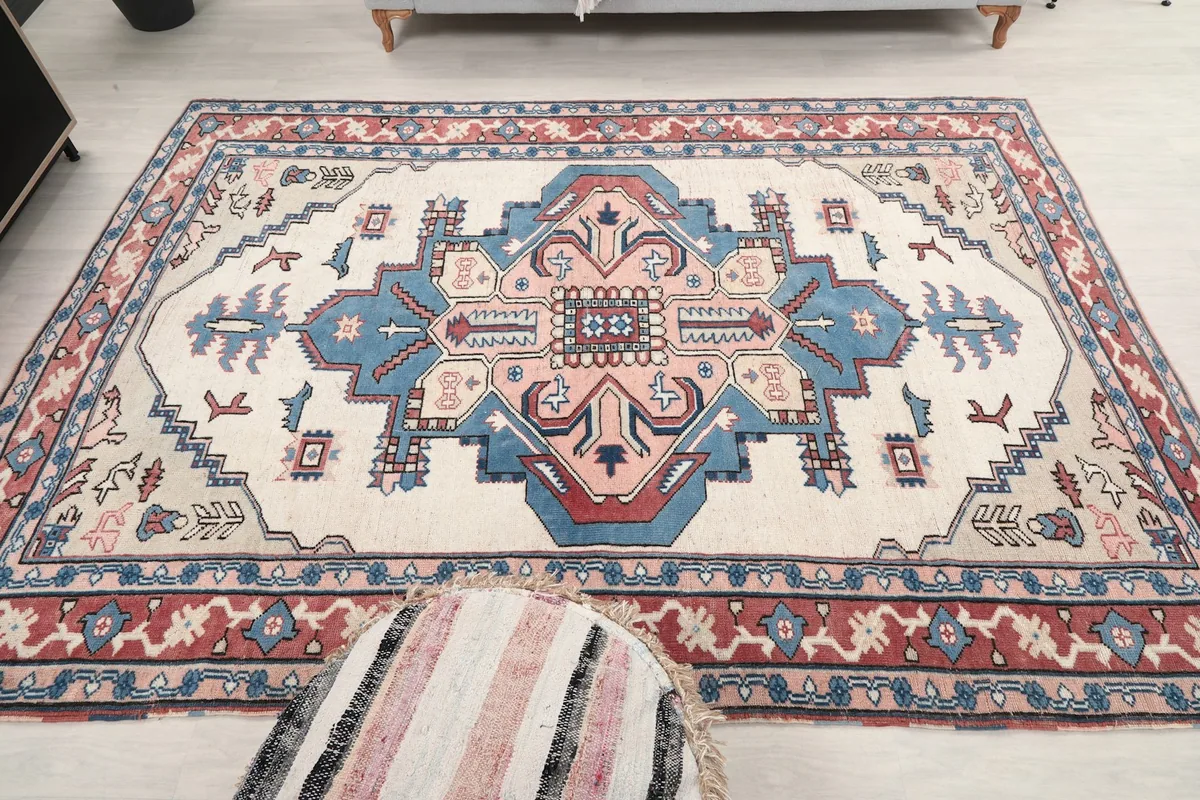Full length shot of the rug in a room, showing its dimensions relative to furniture.