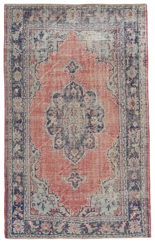Full overhead view of the rust and navy medallion vintage rug