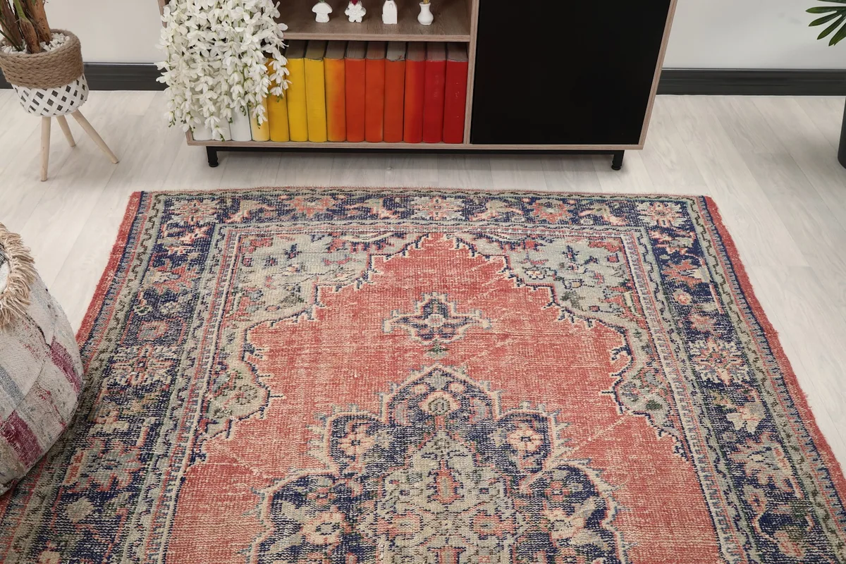 Overhead angle of the rust and navy rug, showcasing its placement in a room