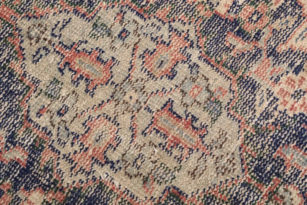 Texture and low pile of the hand-knotted wool rug, showing intricate patterns