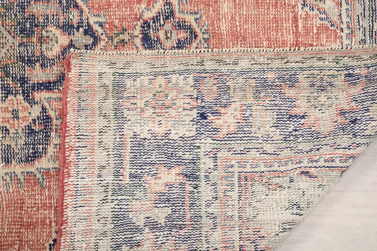 Close-up of the rug's reverse side, showing the hand-knotted construction
