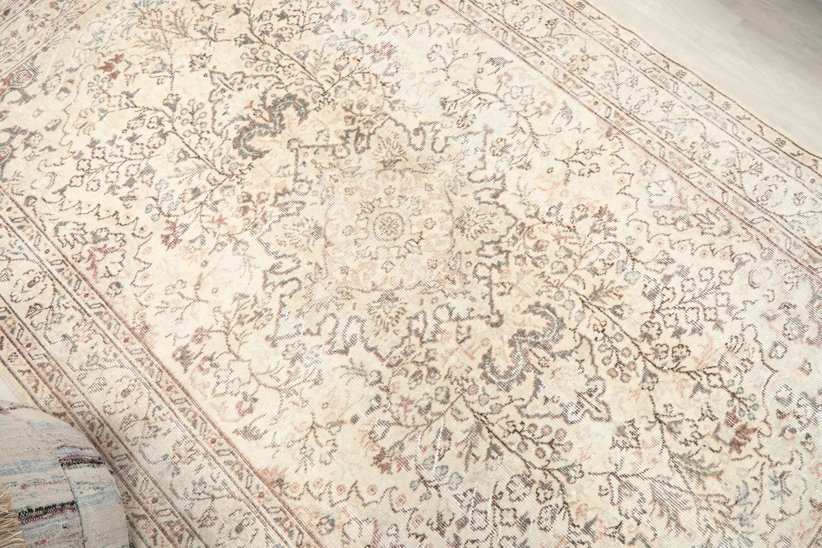 Overhead angle shot highlighting the central medallion and surrounding floral motifs of the rug