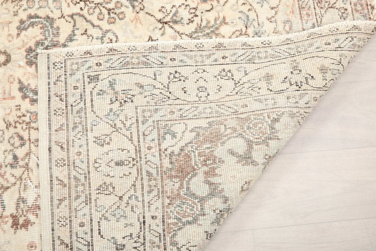 Close-up of the rug's reverse side, showing the knotting structure and weave detail