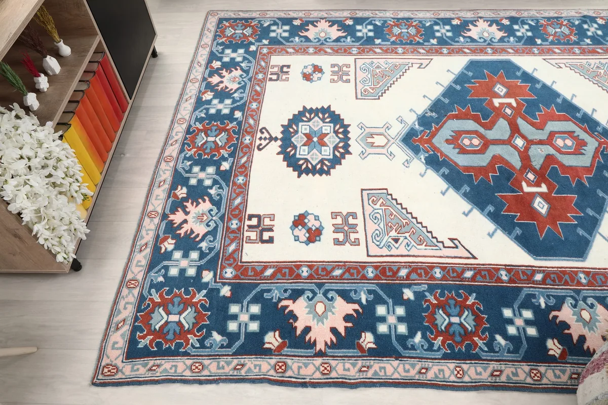 Wide angle view showing the rug's full pattern and colors from a corner perspective