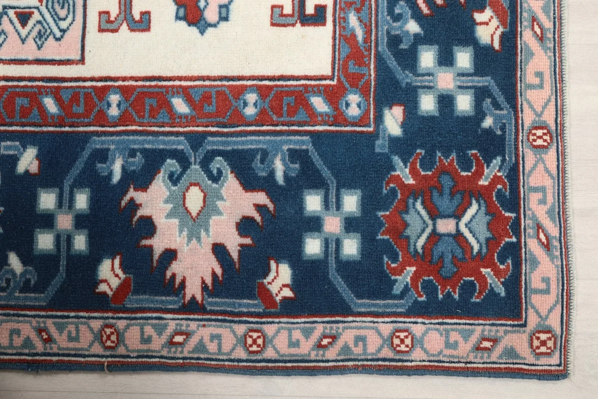 Detailed view of the navy border design with geometric patterns and pink accents