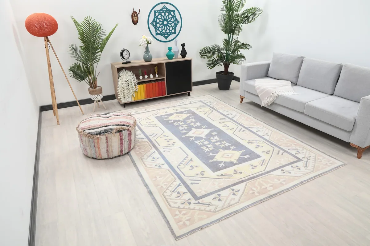 Overhead angle of the 6'7" x 9'0" blue and beige rug in a contemporary room, showing its scale.