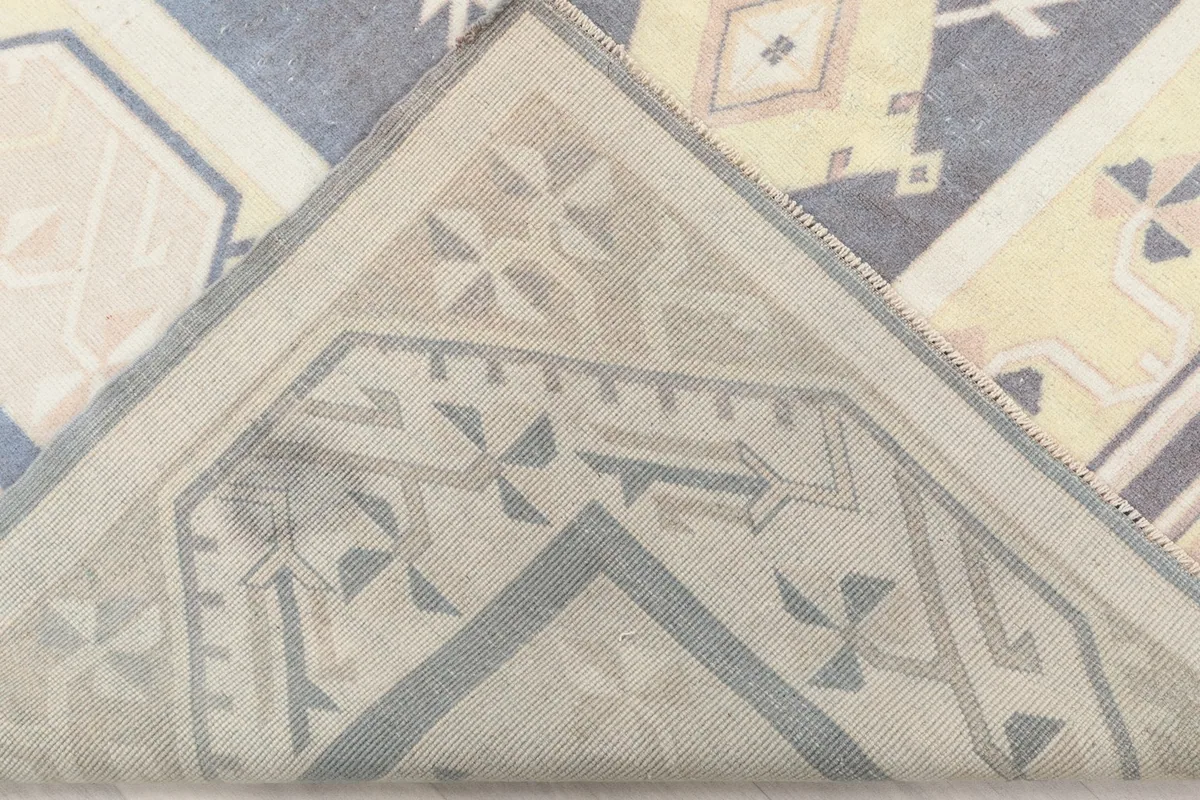Underside of the hand-knotted rug, revealing the cotton foundation and knotting structure.