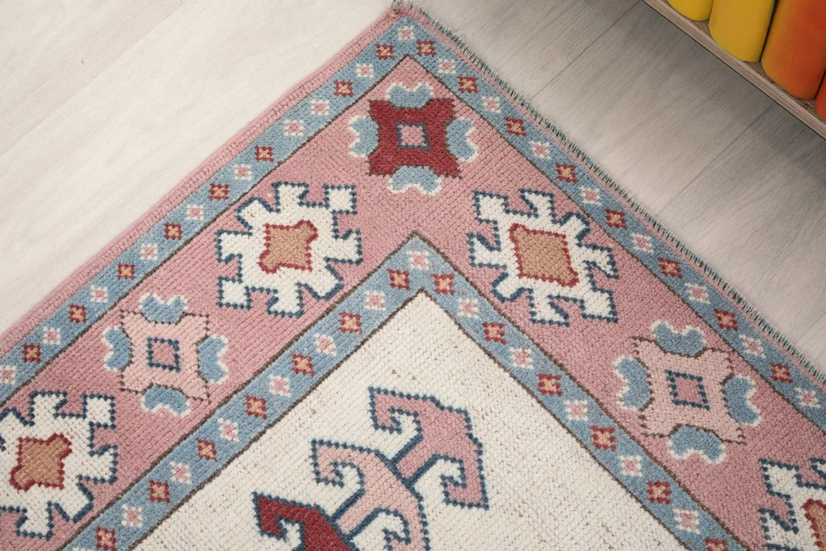 Close-up of a corner showing the geometric border designs and minor wear consistent with age