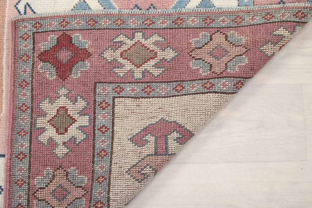 Another view of the rug's underside, showing the tightly woven cotton foundation