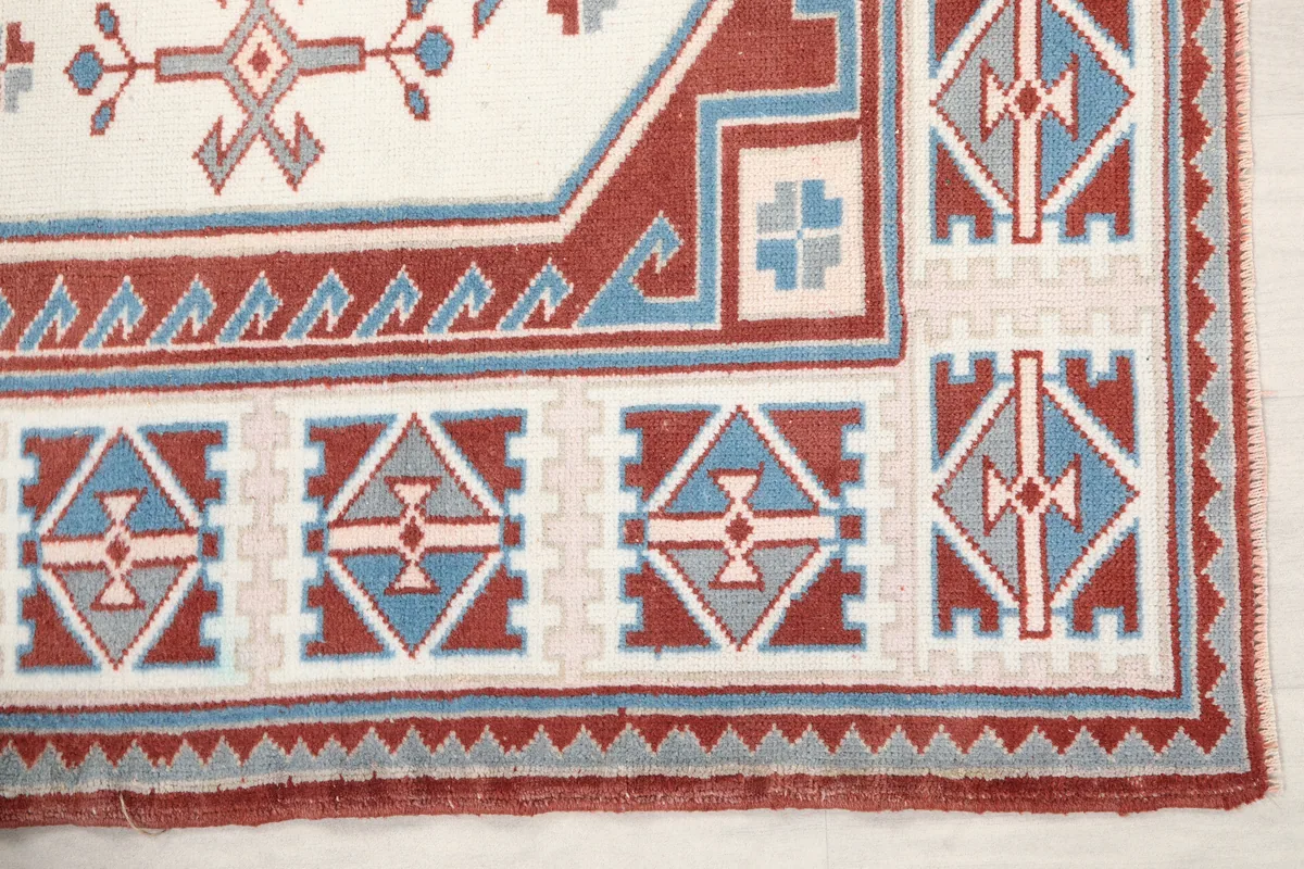 Close-up detail of the Rust Ivory Geometric Anatolian Rug's border and corner motifs