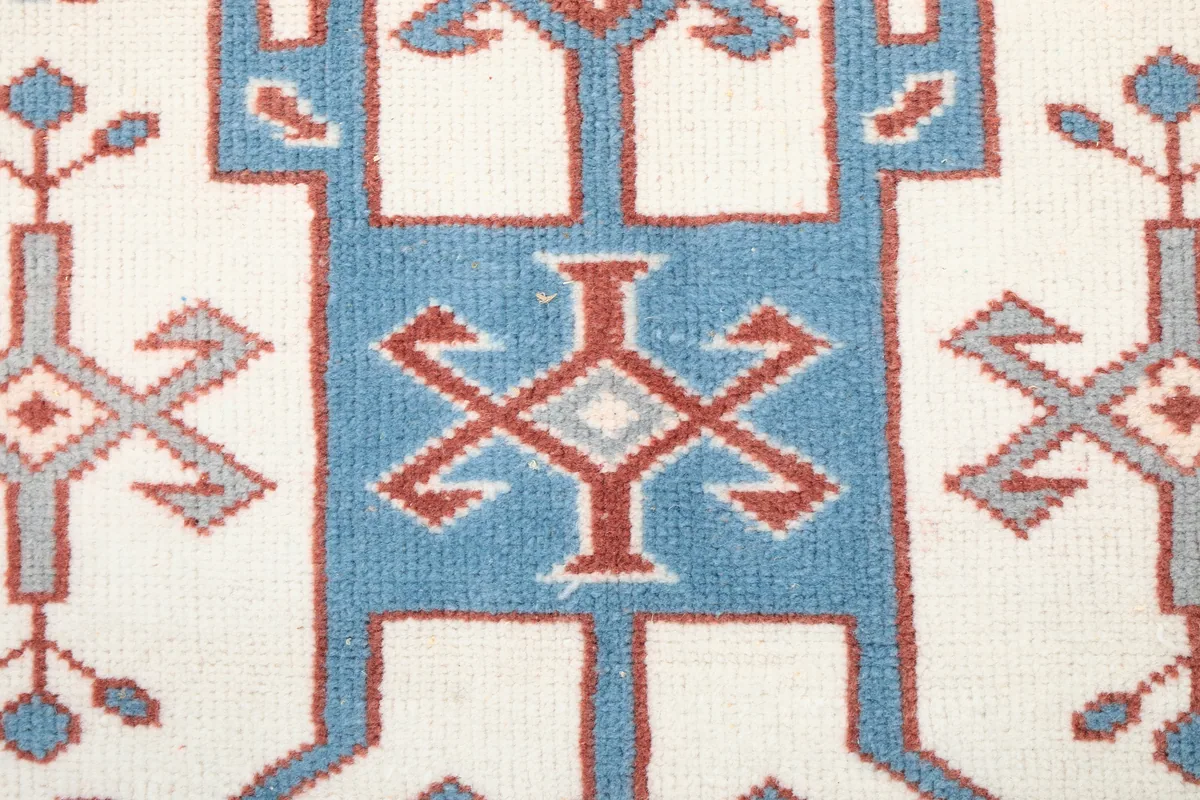 Detailed view of the central blue and rust geometric motif on the Rust Ivory Geometric Anatolian Rug