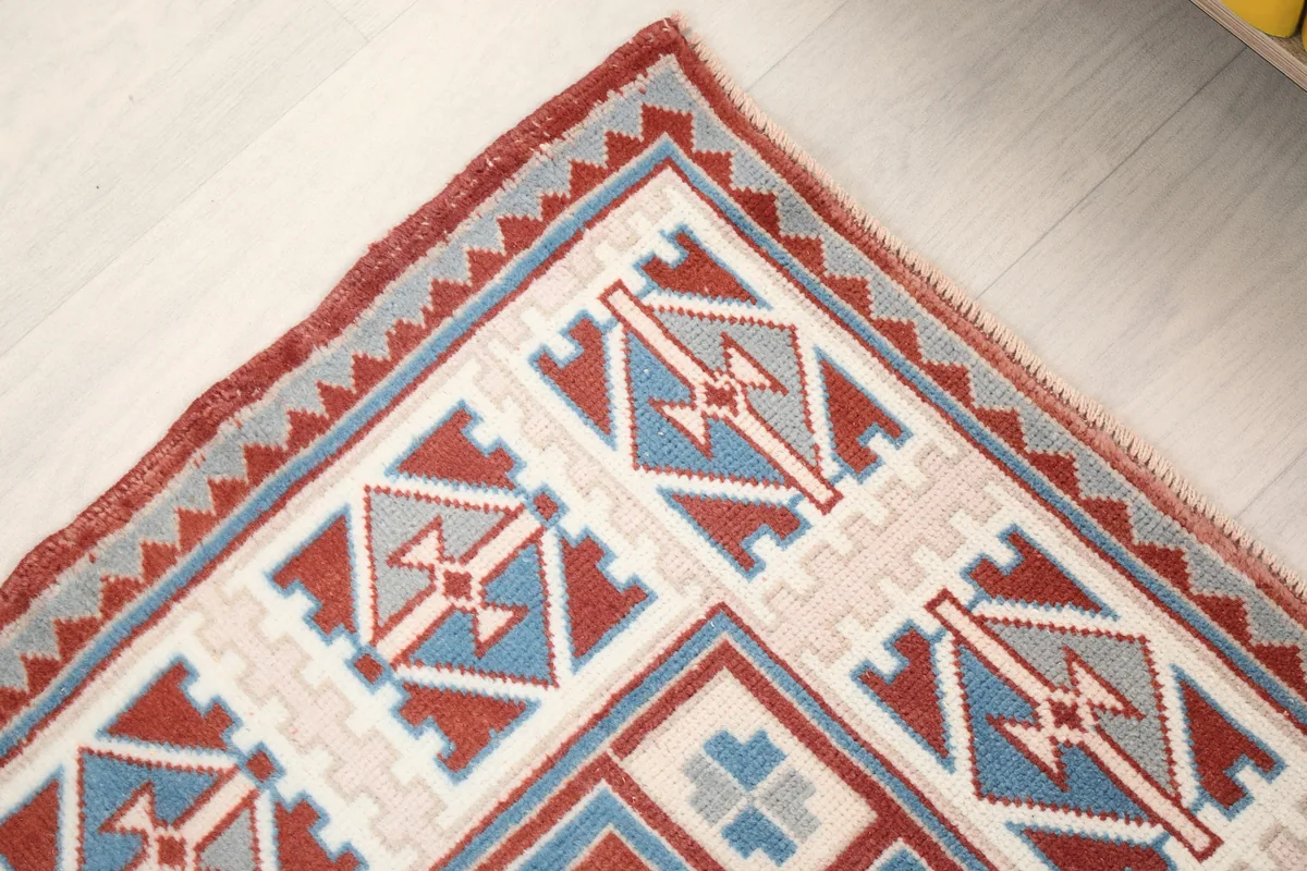 Corner detail of the Rust Ivory Geometric Anatolian Rug, showing the intricate border design