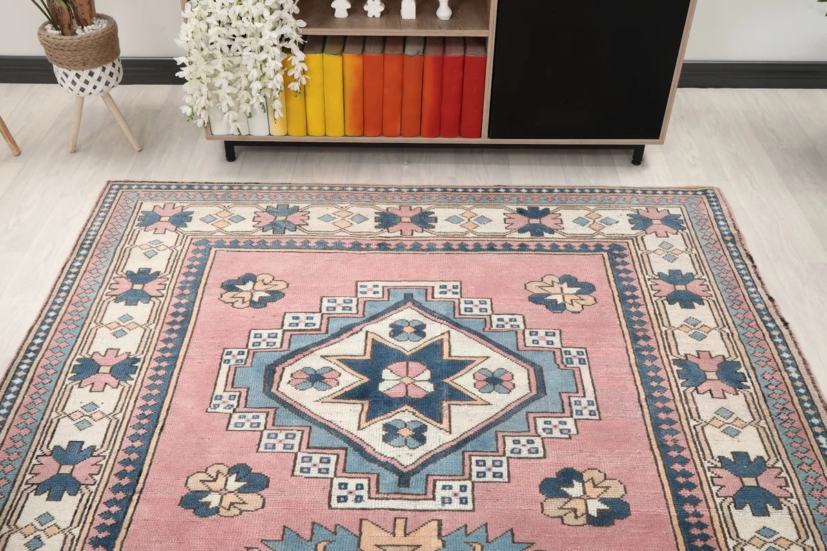 Overhead view of the rug in a room, focusing on the top half and its relation to surrounding decor.