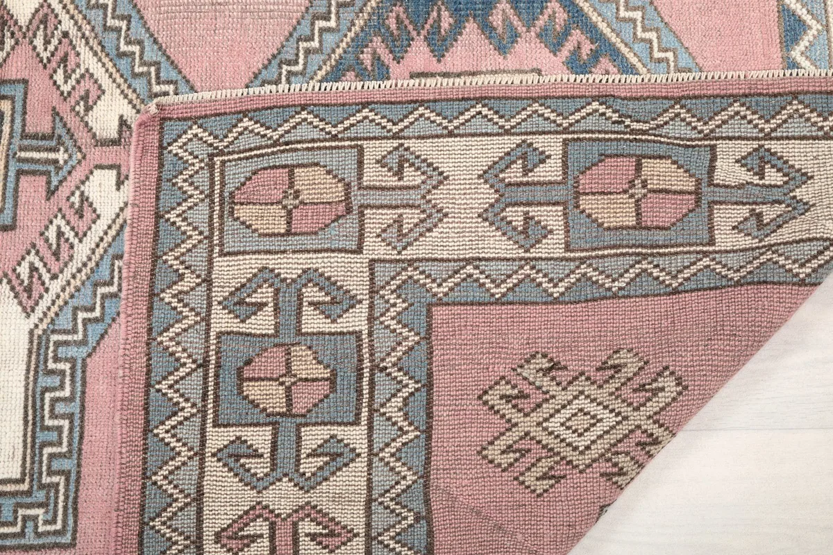 Close-up of the rug's reverse side, showing the hand-knotted cotton foundation