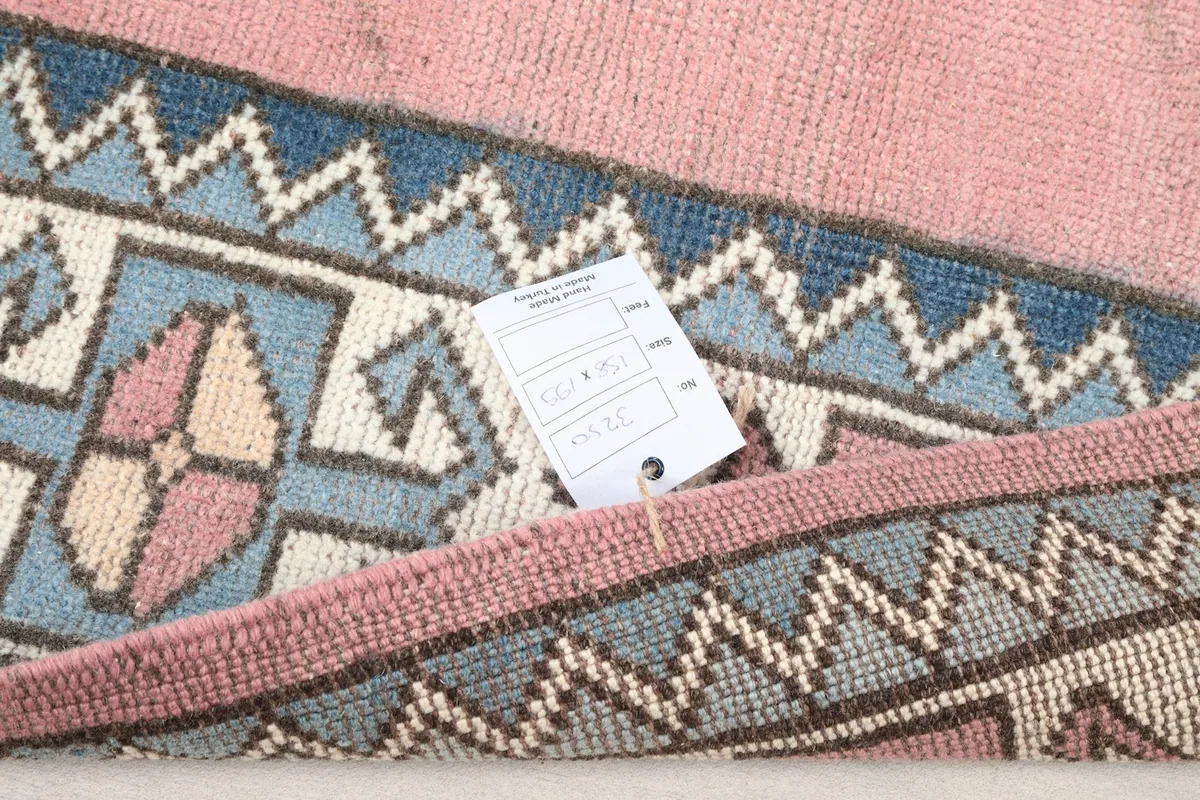 Close-up of the rug with an information tag, showing texture and colors