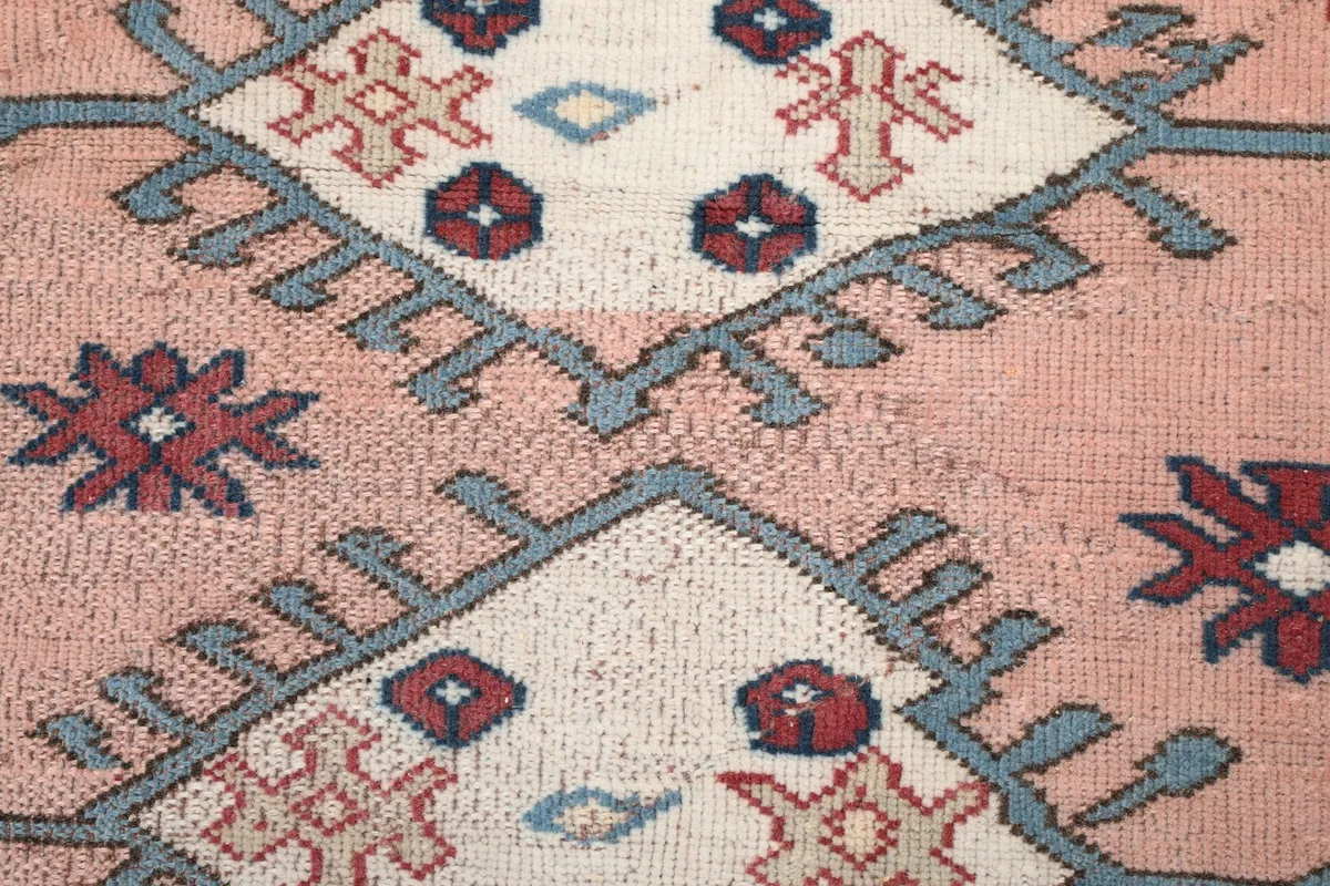 Close-up of the low wool pile and intricate knotting, highlighting the texture and colors
