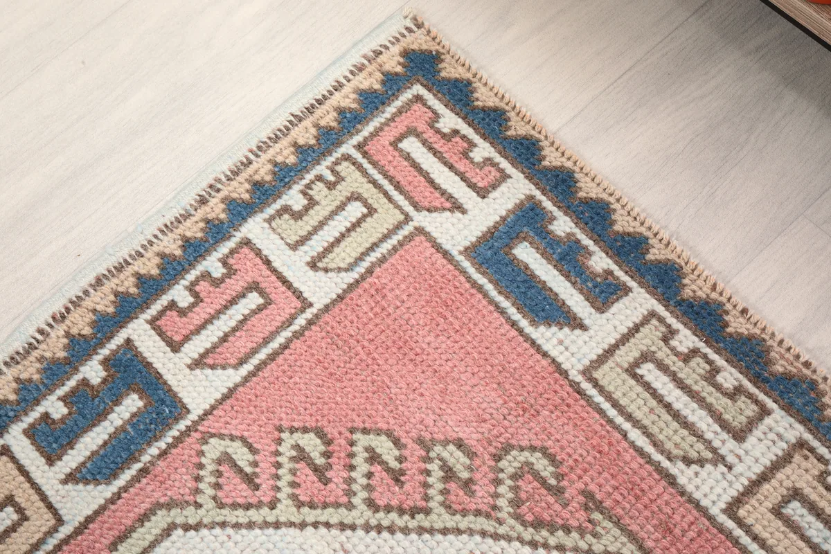 Rose Geometric Star Rug, close-up of a corner, displaying the intricate tribal patterns of the border.