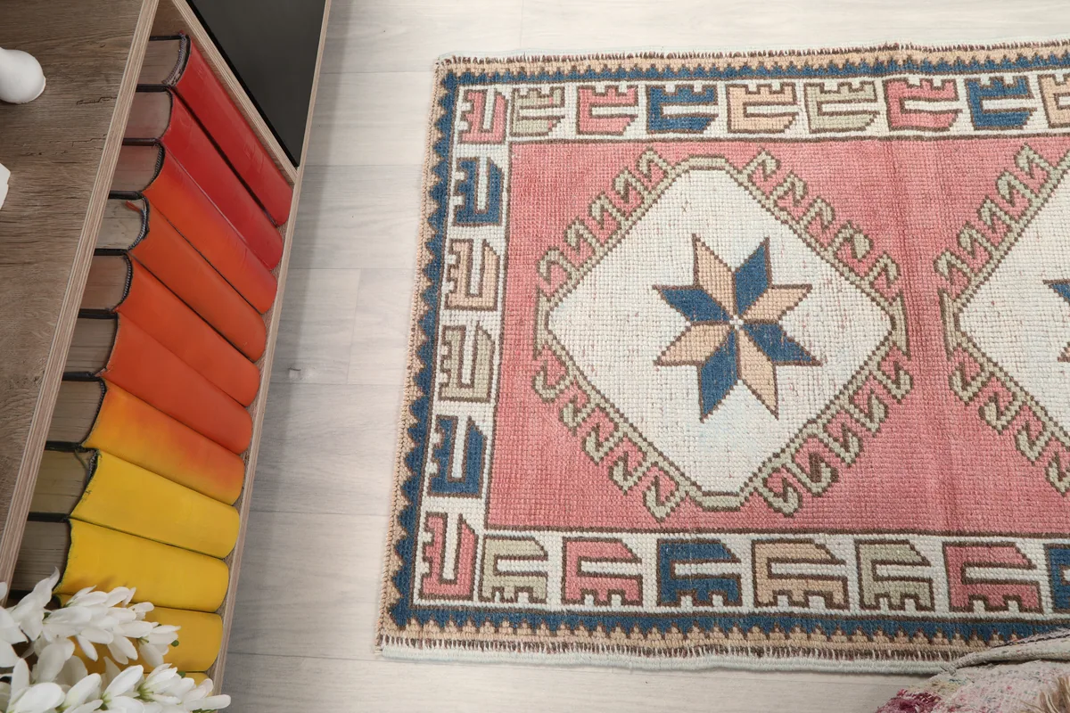 Rose Geometric Star Rug, view from above, showing part of the rug and the surrounding room elements.