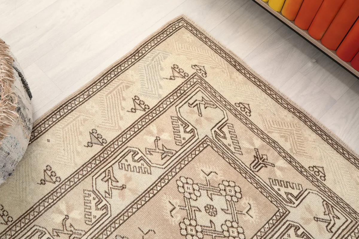 Corner detail of the rug, showing the intricate geometric border and field patterns.
