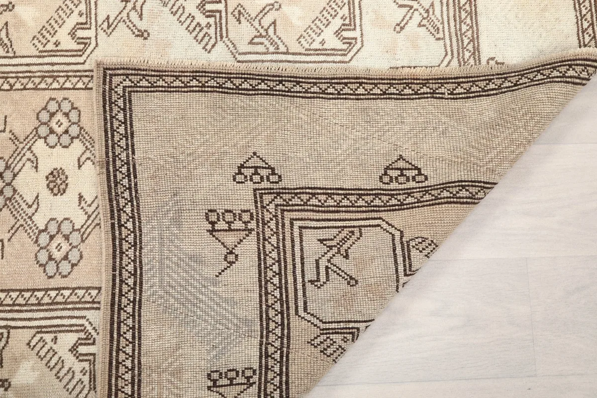 Close-up of the rug's backside, revealing the cotton foundation and tight hand-knotted wool pile.