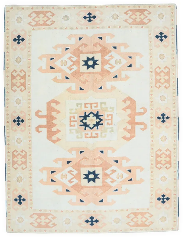 Full overhead view of the vintage Anatolian rug with an ivory field and rust geometric patterns
