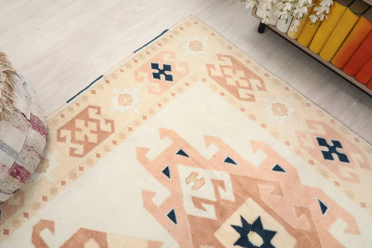 Angled view showcasing the top right corner of the rug and the intricate border designs