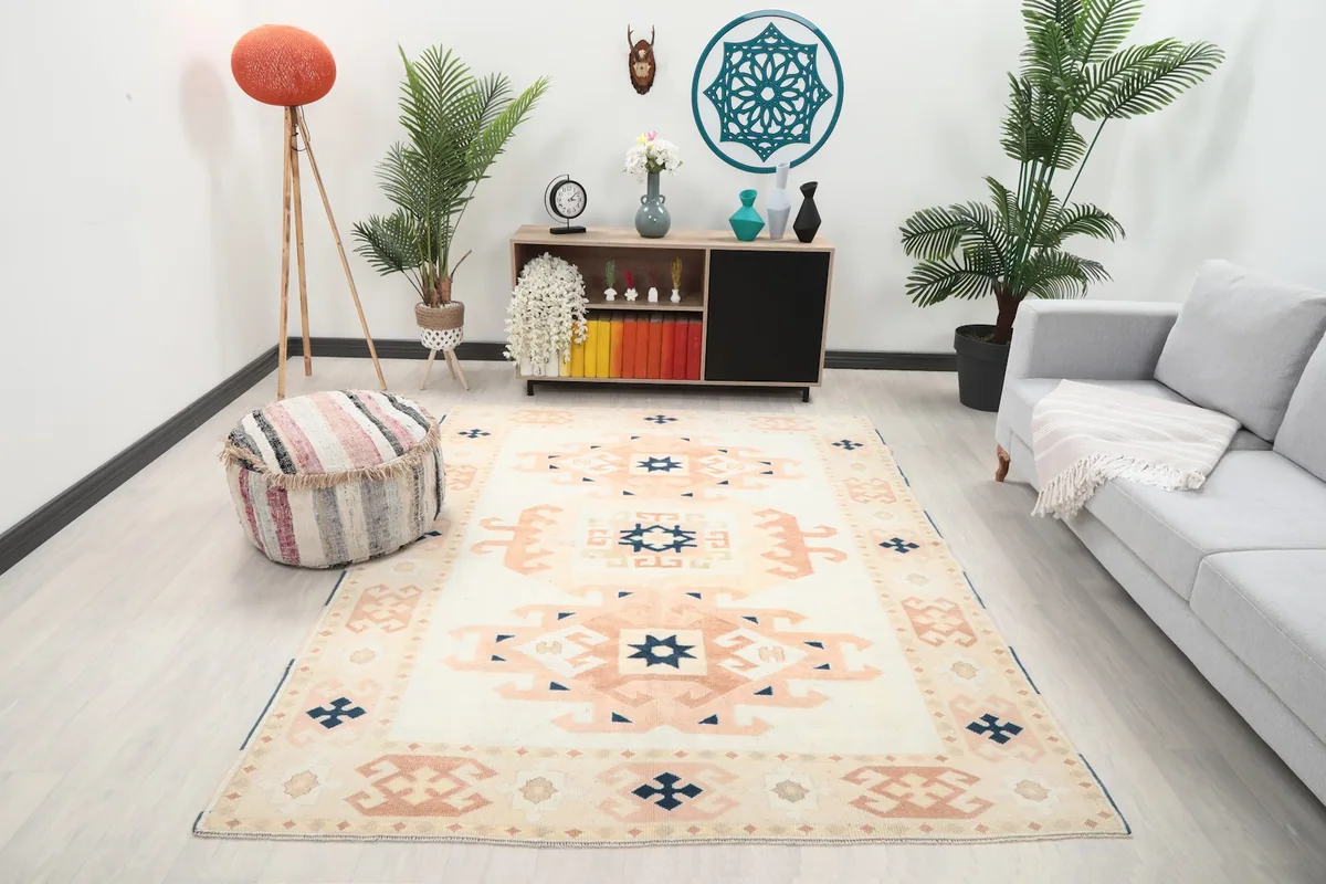 Vintage Anatolian rug displayed in a living room setting with a light gray sofa and wooden cabinet