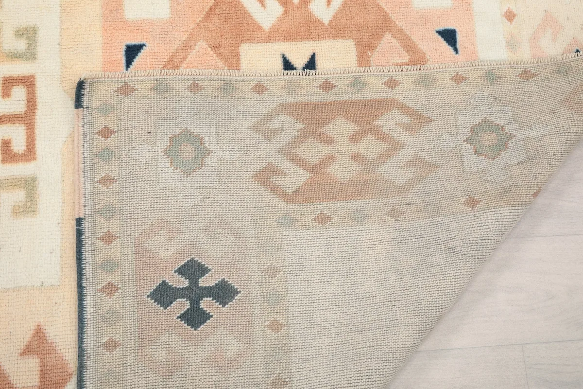 Close-up of the rug's back, showing the hand-knotted construction and the foundation weave