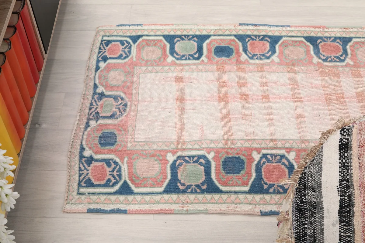 Overhead angled view of one end of the runner rug, showing the full border pattern