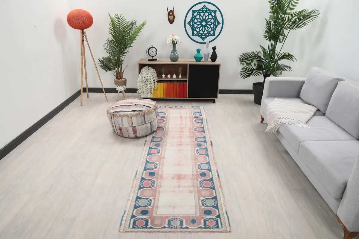 Vintage Anatolian runner rug displayed in a living room setting with modern furniture