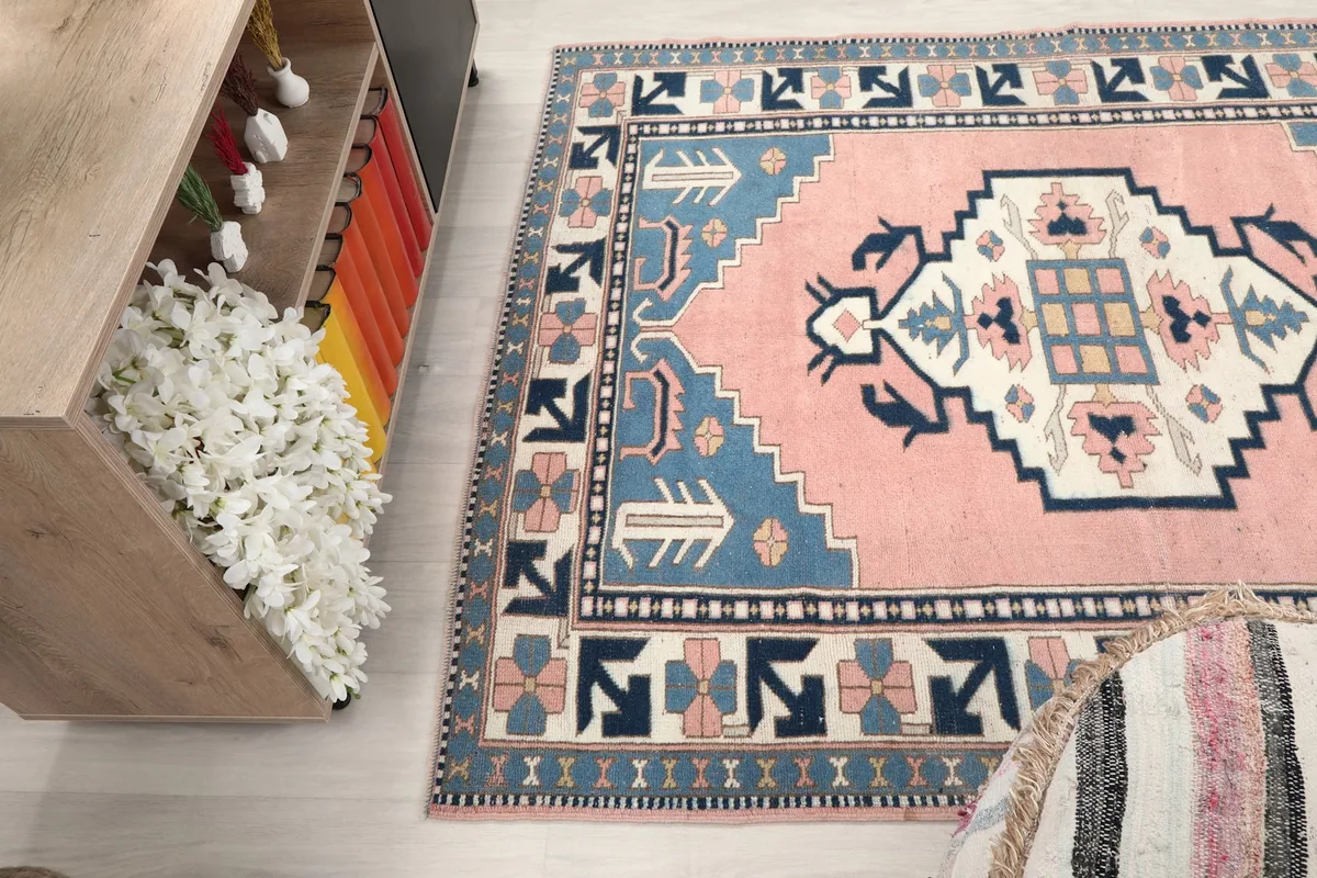 Angled view of the rug's patterns and colors, seen next to a cabinet