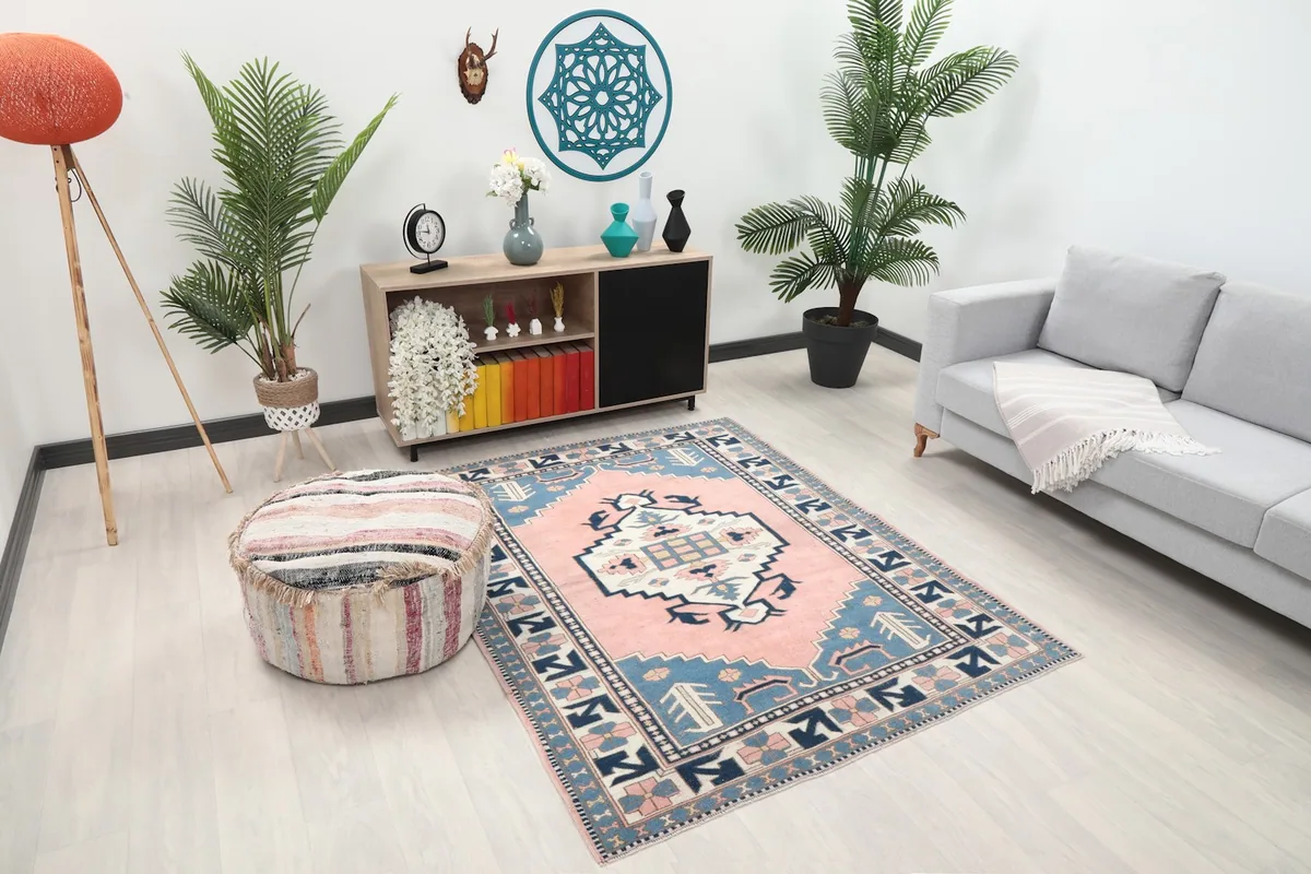 Overhead view of the pink and blue geometric rug in a modern living room setup