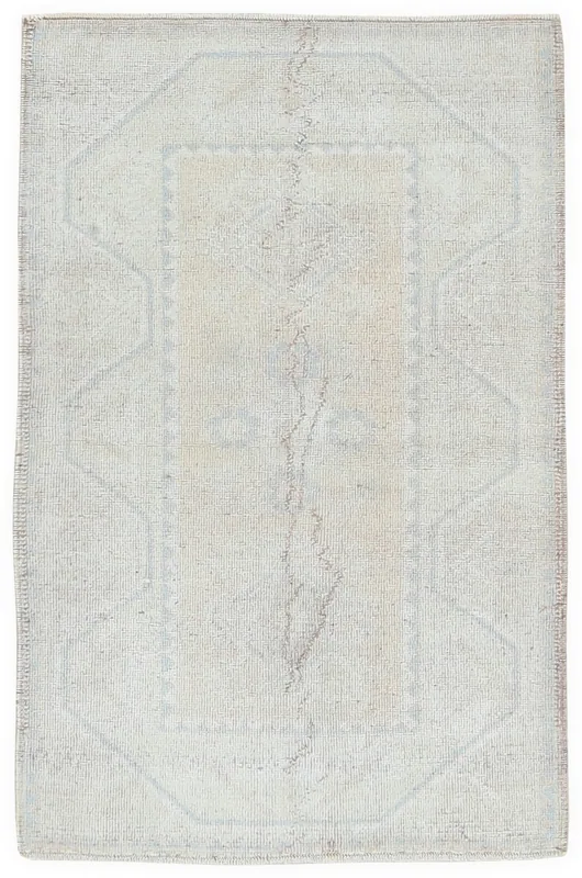 Full overhead view of the beige and blue vintage Anatolian rug on a white background