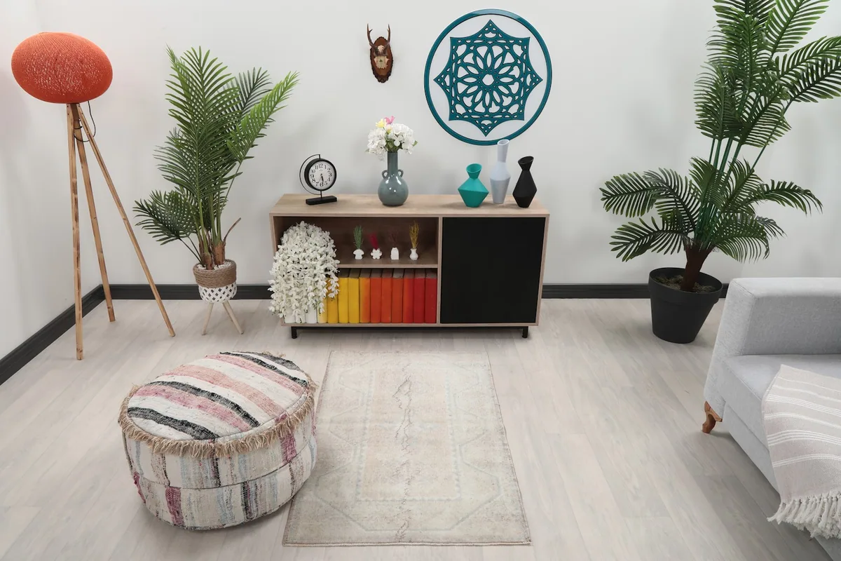 Vintage beige geometric rug styled in a living room scene with light flooring and modern furniture