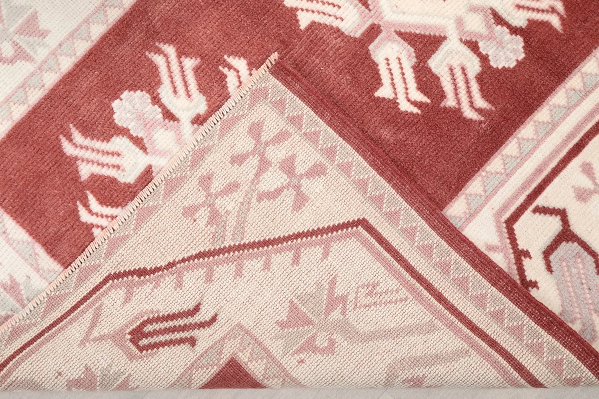 View of the rug's back, revealing the cotton foundation and hand-knotted construction