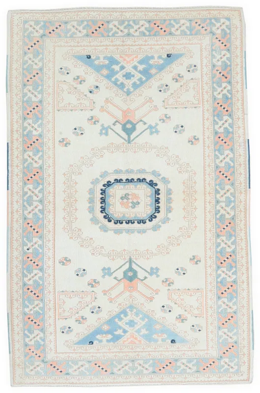 Full top view of the 3'11" x 6'1" vintage Anatolian rug with ivory field and rose, blue, and navy geometric patterns.
