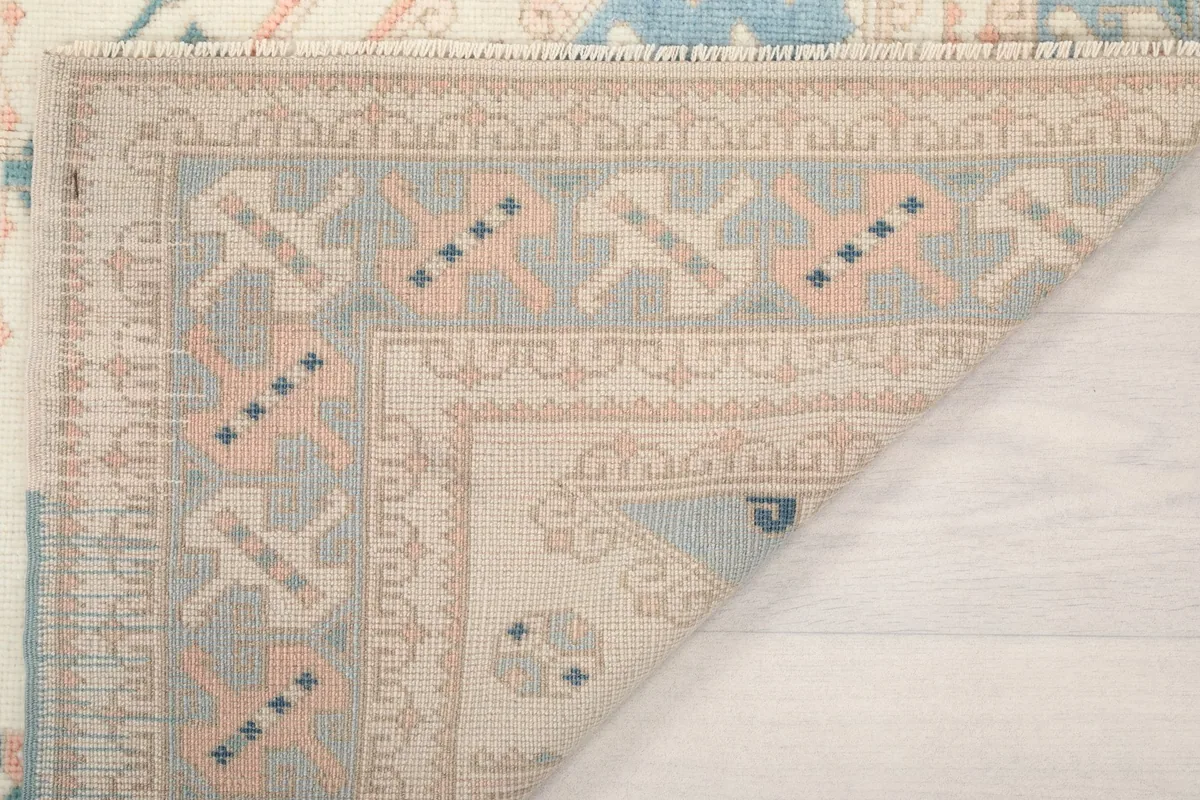 Another view of the rug's folded corner, showing the craftsmanship of the hand-knotted construction.