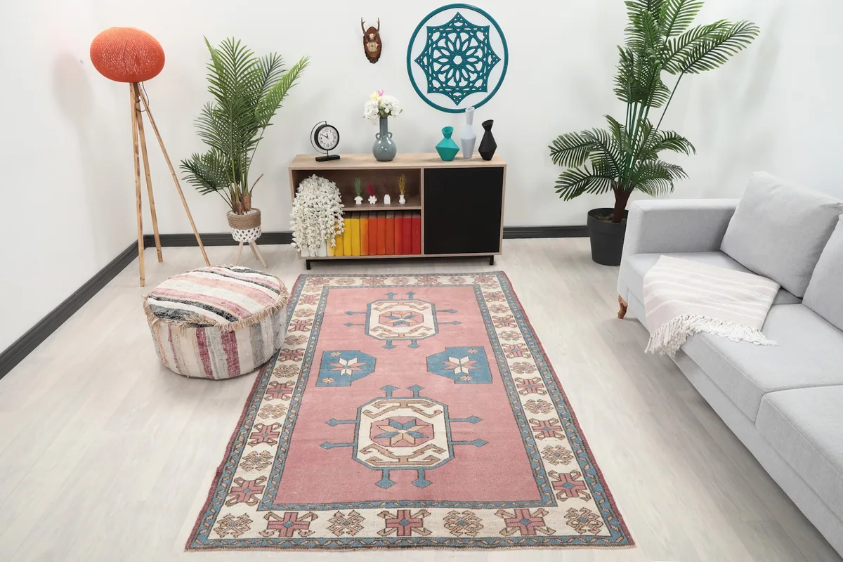 Vintage Anatolian rug in a modern living room setting with a gray sofa and wooden cabinet