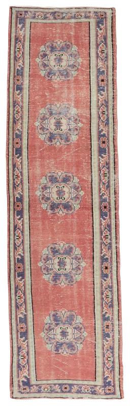 Full top view of the 2'9" x 10'10" rose and navy medallion vintage Anatolian runner rug on a white background
