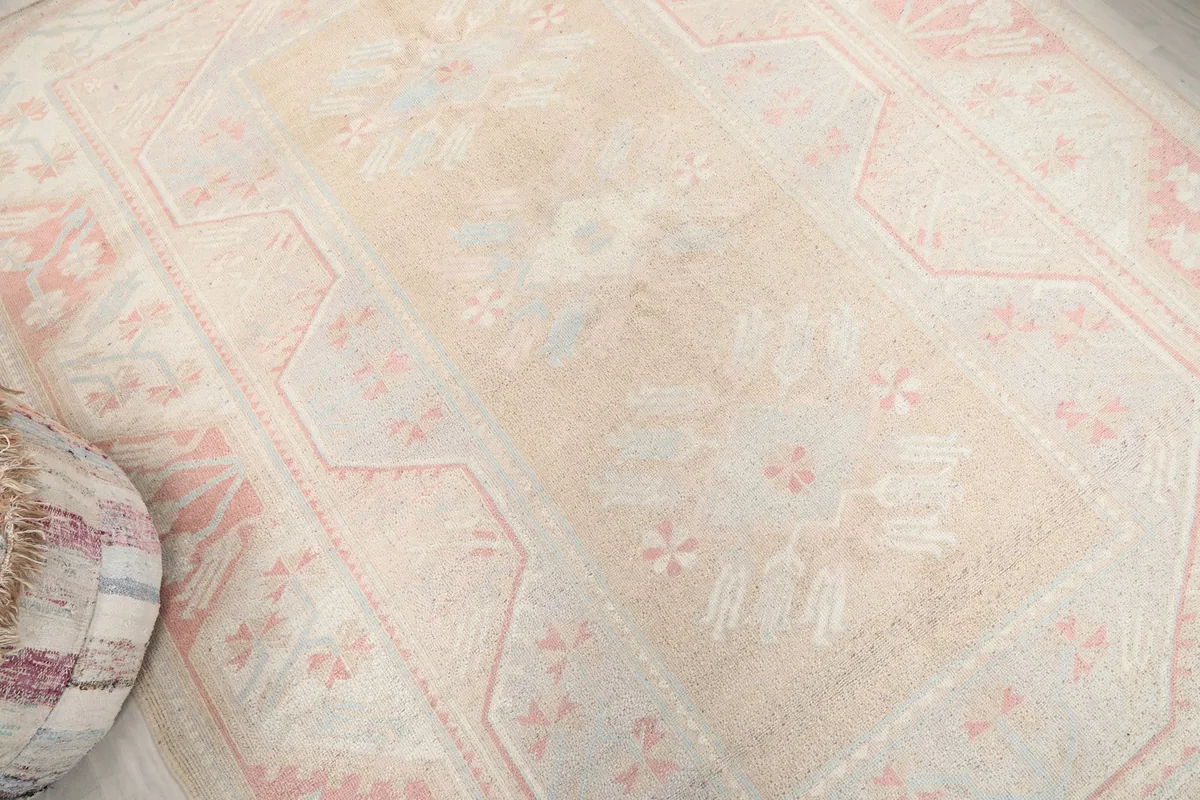 Overhead angle showing the central beige field and surrounding rose border