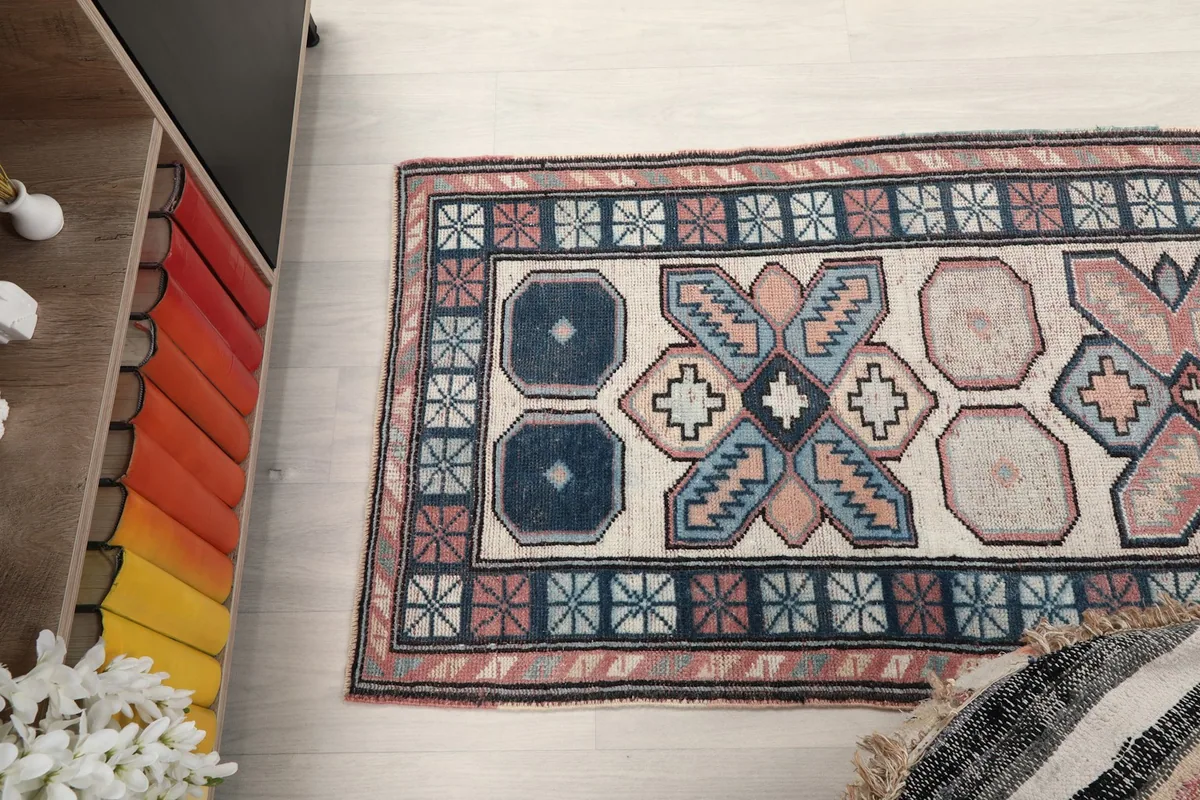 Overhead shot of one end of the runner rug, showing the geometric patterns and border design.