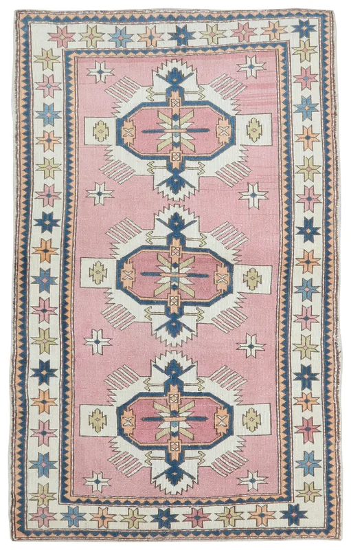 Full overhead view of the rose tribal geometric vintage Anatolian area rug.