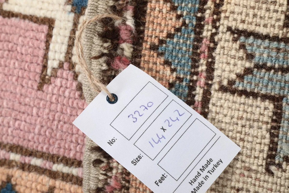 Close-up of the rug's back with a tag showing size and origin details.