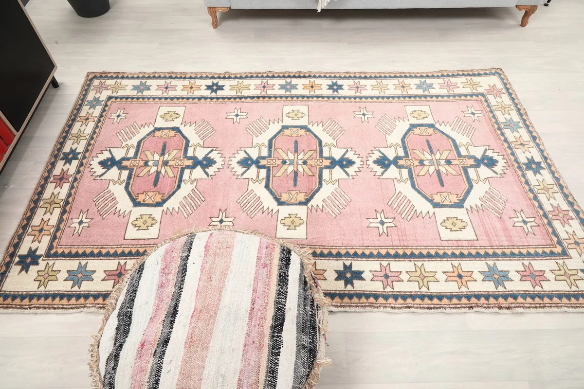 Overhead view of the vintage rug, showing the full design and colors.