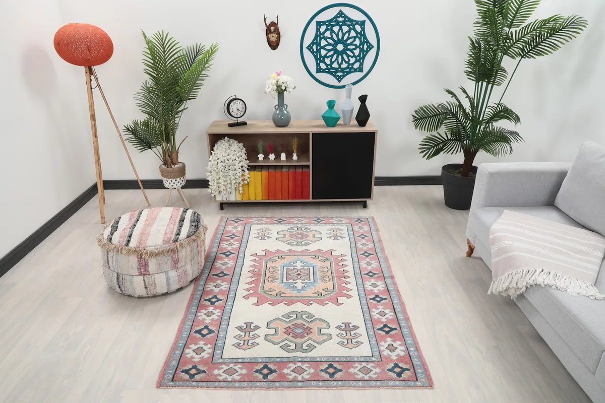 Vintage Anatolian rug in a room setting with a sofa and ottoman