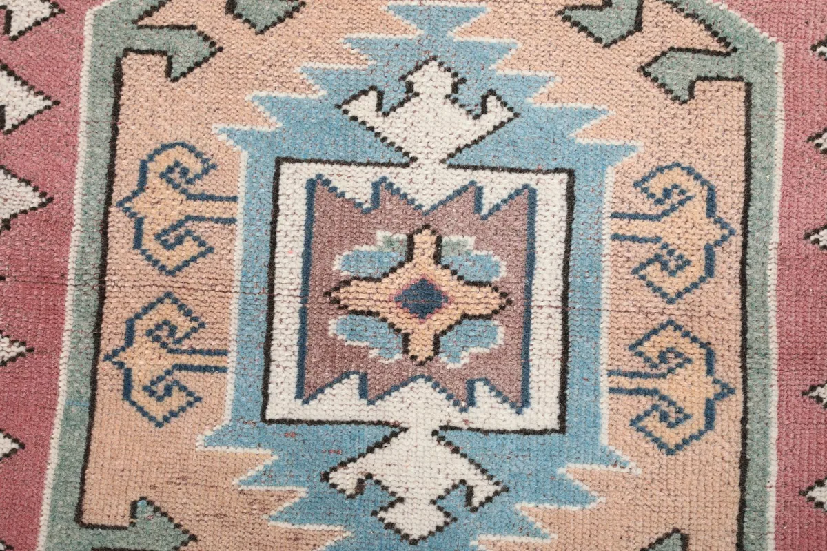 Detailed shot of the blue and orange geometric design within the medallion