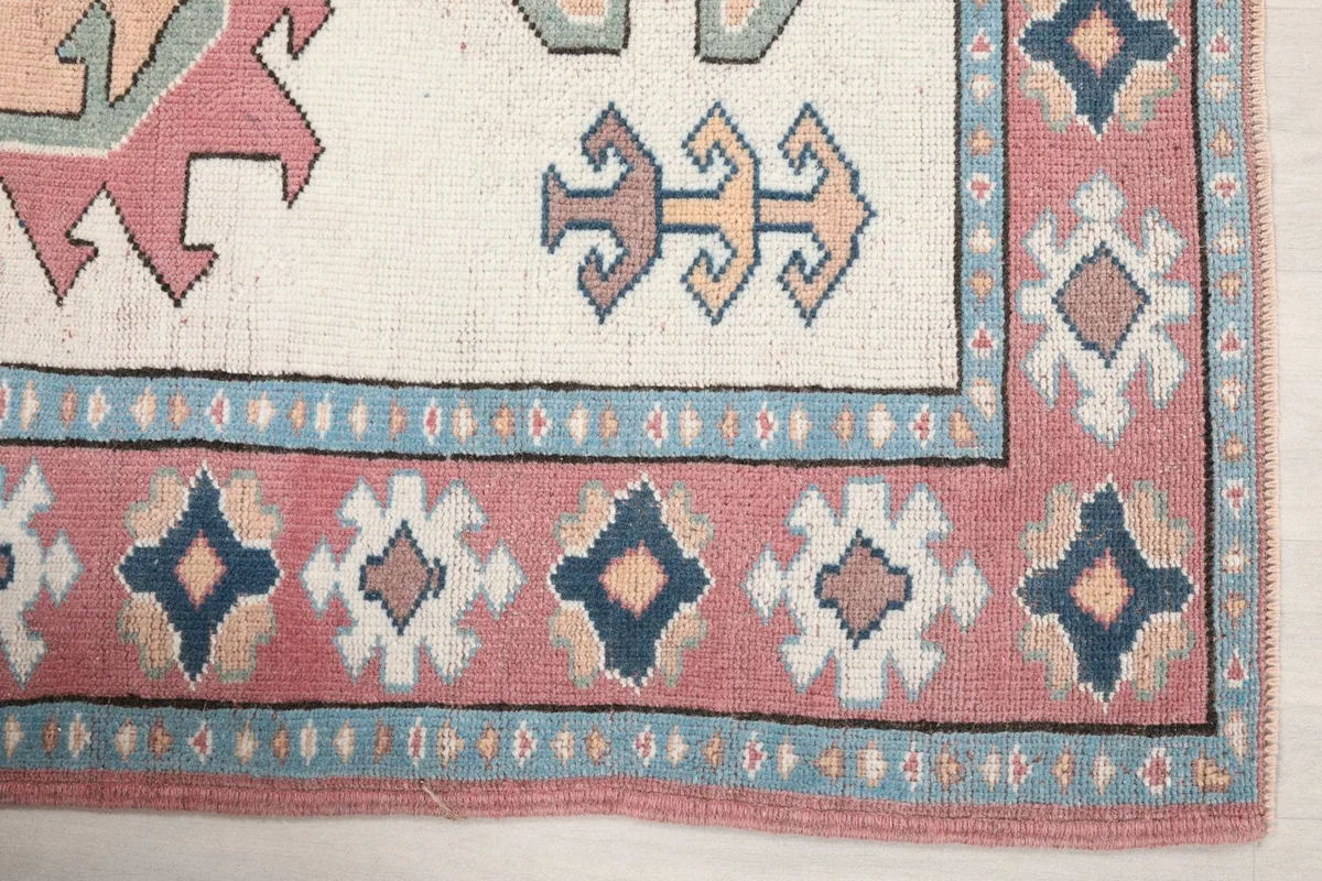 Detail of the rose border and corner motifs with blue accents