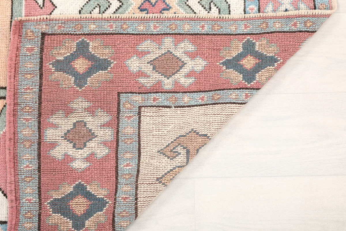 View of the rug's back, showing the hand-knotted cotton foundation